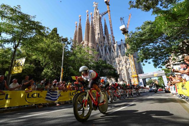 Netcompany INEOS team riders cycle past the Sagrada Familia Basilica during the 1st stage of the 113th edition of the Tour de France cycling race, a 19,6 km team time trial stage in and around Barcelona in northeastern Spain, on July 4, 2026. (Photo by Anne-Christine POUJOULAT / AFP)