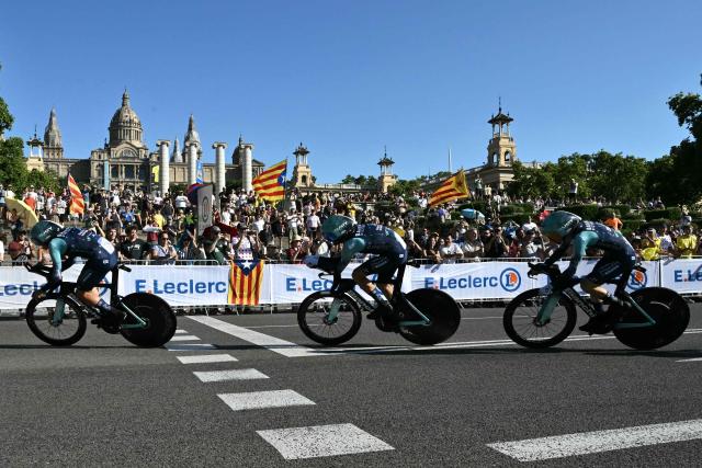 The team Bahrain Victorious cycles next to the Palau nacional ('National Palace')  on the hill of Montjuic during the 1st stage of the 113th edition of the Tour de France cycling race, a 19,6 km team time trial stage in and around Barcelona in northeastern Spain, on July 4, 2026. (Photo by Jeff PACHOUD / AFP)