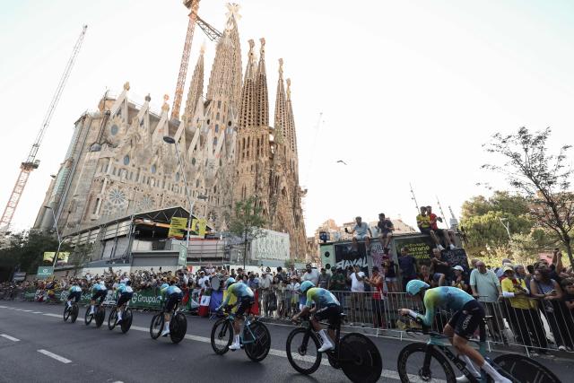 XDS Astana Team riders cycle past the Sagrada Familia Basilica during the 1st stage of the 113th edition of the Tour de France cycling race, a 19,6 km team time trial stage in and around Barcelona in northeastern Spain, on July 4, 2026. (Photo by Josep LAGO / AFP)