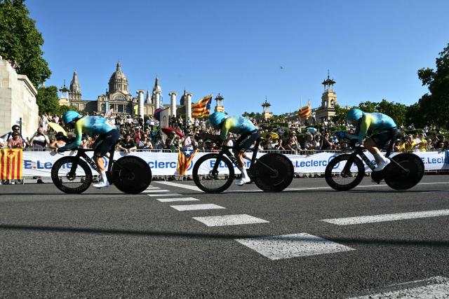 The team XDS-Astana cycles next to the Palau nacional ('National Palace')  on the hill of Montjuic during the 1st stage of the 113th edition of the Tour de France cycling race, a 19,6 km team time trial stage in and around Barcelona in northeastern Spain, on July 4, 2026. (Photo by Jeff PACHOUD / AFP)