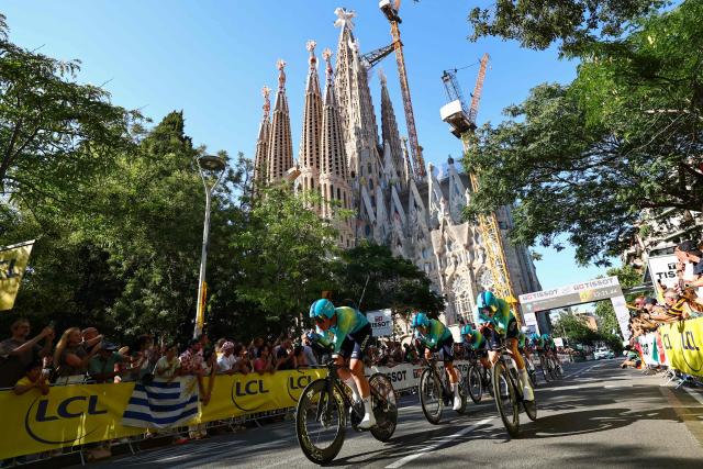 XDS Astana Team riders cycle past the Sagrada Familia Basilica during the 1st stage of the 113th edition of the Tour de France cycling race, a 19,6 km team time trial stage in and around Barcelona in northeastern Spain, on July 4, 2026. (Photo by Anne-Christine POUJOULAT / AFP)