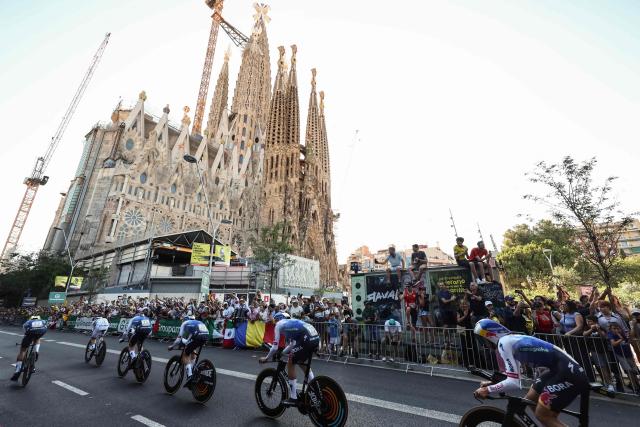 Red Bull - BORA - Hansgrohe team riders cycle past the Sagrada Familia Basilica during the 1st stage of the 113th edition of the Tour de France cycling race, a 19,6 km team time trial stage in and around Barcelona in northeastern Spain, on July 4, 2026. (Photo by Josep LAGO / AFP)