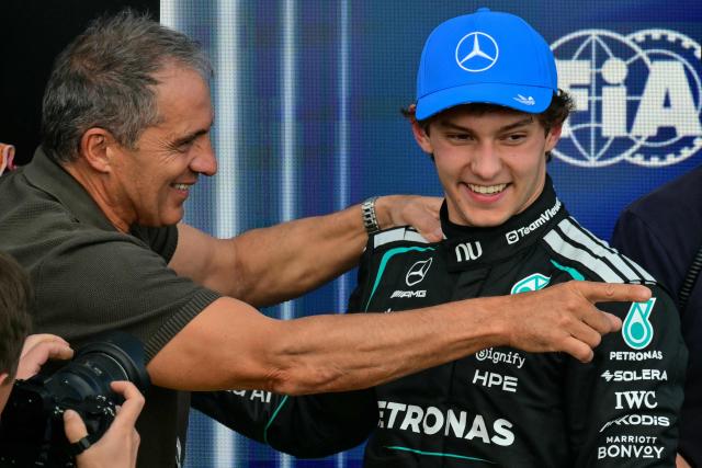 Mercedes' Italian driver Kimi Antonelli (R) celebrates with his father Marco (L) after taking pole position in the qualifying session ahead of the Formula One British Grand Prix at the Silverstone motor racing circuit in Silverstone, central England, on July 4, 2026. (Photo by Andrej ISAKOVIC / AFP)