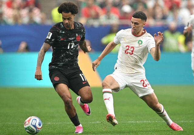 Canada's midfielder #17 Tajon Buchanan and Morocco's midfielder #23 Bilal El Khannouss fight for the ball during the 2026 World Cup round of 16 football match between Canada and Morocco at the Houston Stadium in Houston on July 4, 2026.  (Photo by RONALDO SCHEMIDT / AFP)