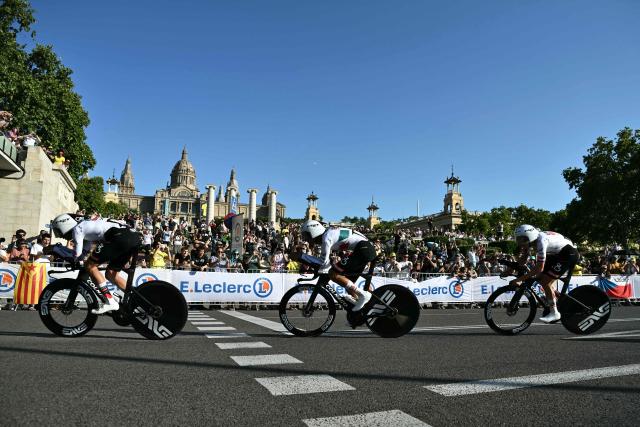 UAE Team Emirates - XRG's Slovenian rider Tadej Pogacar (R) cycles with his team next to the Palau nacional ('National Palace')  on the hill of Montjuic during the 1st stage of the 113th edition of the Tour de France cycling race, a 19,6 km team time trial stage in and around Barcelona in northeastern Spain, on July 4, 2026. (Photo by Jeff PACHOUD / AFP)