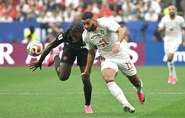 Canada's defender #15 Moise Bombito and Morocco's midfielder #11 Ismael Saibari fight for the ball during the 2026 World Cup round of 16 football match between Canada and Morocco at the Houston Stadium in Houston on July 4, 2026.  (Photo by Paul ELLIS / AFP)