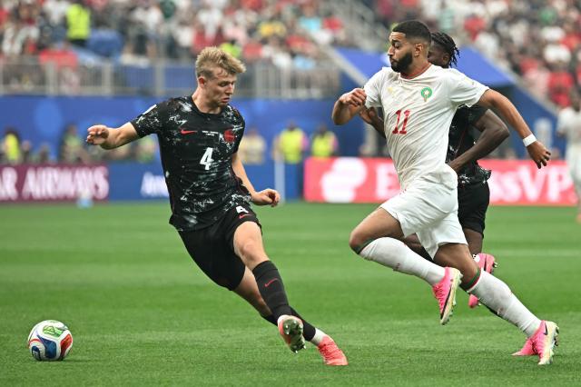 Canada's defender #04 Luc de Fougerolles and Morocco's midfielder #11 Ismael Saibari fight for the ball during the 2026 World Cup round of 16 football match between Canada and Morocco at the Houston Stadium in Houston on July 4, 2026.  (Photo by Paul ELLIS / AFP)