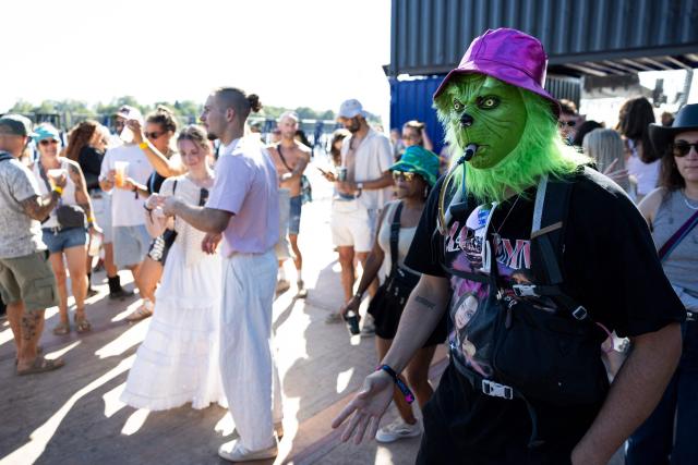A festivalgoer wearing a Grinch mask dances during the 36th edition of the Eurockeennes de Belfort music festival, in Sermamagny, eastern France, on July 4, 2026. (Photo by ROMEO BOETZLE / AFP)