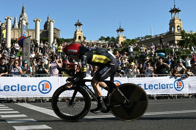 TOPSHOT - Team Visma | Lease a Bike's Danish rider Jonas Vingegaard cycles next to the Palau nacional ('National Palace')  on the hill of Montjuic during the 1st stage of the 113th edition of the Tour de France cycling race, a 19,6 km team time trial stage in and around Barcelona in northeastern Spain, on July 4, 2026. (Photo by Jeff PACHOUD / AFP)