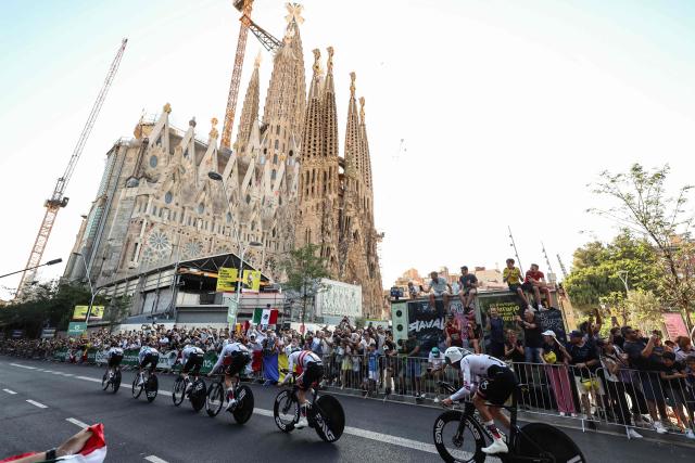 UAE Emirates - XRG team riders cycle past the Sagrada Familia Basilica during the 1st stage of the 113th edition of the Tour de France cycling race, a 19,6 km team time trial stage in and around Barcelona in northeastern Spain, on July 4, 2026. (Photo by Josep LAGO / AFP)
