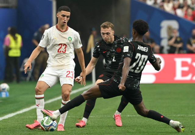 Morocco's midfielder #23 Bilal El Khannouss controlls the ball past Canada's defender #02 Alistair Johnston and midfielder #20 Ali Ahmed during the 2026 World Cup round of 16 football match between Canada and Morocco at the Houston Stadium in Houston on July 4, 2026.  (Photo by RONALDO SCHEMIDT / AFP)