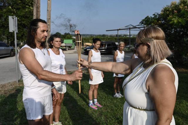 Reenactors dressed as ancient Greeks perform a ritual at the foothills of Mount Olympus as part of the four-day Promitheia Festival honouring ancient Greek Gods, near Litochoro, northern Greece, on July 3, 2026. (Photo by Sakis Mitrolidis / AFP)