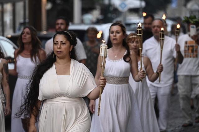 Reenactors dressed as ancient Greeks parade with torches through Litochoro as part of the four-day Promitheia Festival honouring ancient Greek Gods, in Litochoro, northern Greece, on July 3, 2026. (Photo by Sakis Mitrolidis / AFP)