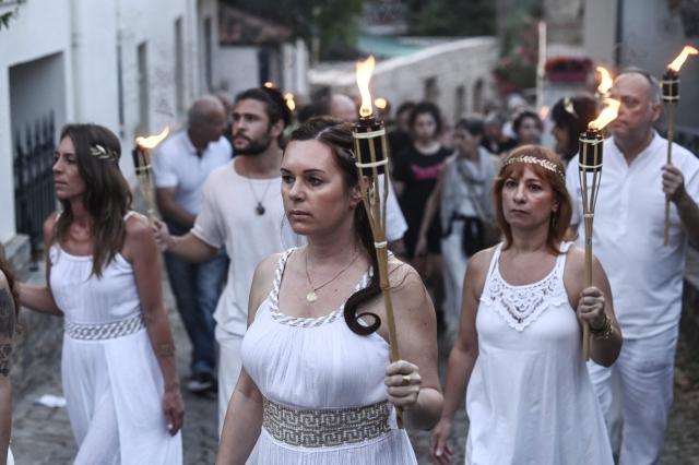 Reenactors dressed as ancient Greeks parade with torches through Litochoro as part of the four-day Promitheia Festival honouring ancient Greek Gods, in Litochoro, northern Greece, on July 3, 2026. (Photo by Sakis Mitrolidis / AFP)