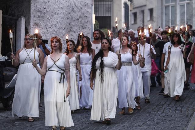 Reenactors dressed as ancient Greeks parade with torches through Litochoro as part of the four-day Promitheia Festival honouring ancient Greek Gods, in Litochoro, northern Greece, on July 3, 2026. (Photo by Sakis Mitrolidis / AFP)