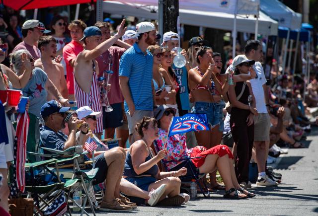 People cheer during the 4th of July parade in Bristol, Rhode Island, on July 4, 2026. Millions of Americans celebrated the country's 250th birthday on Saturday -- a landmark celebration that comes at a time of deep political division, with a president determined to put his stamp on the festivities. Washington's traditional fireworks display on the National Mall -- lined with monuments celebrating the nation's Founding Fathers -- has been super-sized, and is being touted as the biggest ever. (Photo by JOSEPH PREZIOSO / AFP)