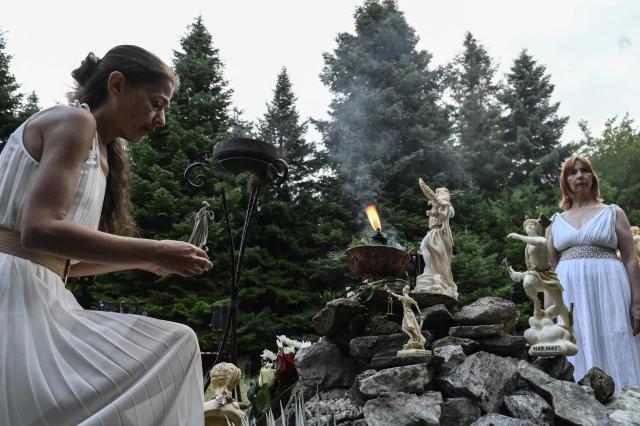 Reenactors dressed as ancient Greeks perform a ritual at the foothills of Mount Olympus as part of the four-day Promitheia Festival honouring ancient Greek Gods, near Litochoro, northern Greece, on July 3, 2026. (Photo by Sakis Mitrolidis / AFP)