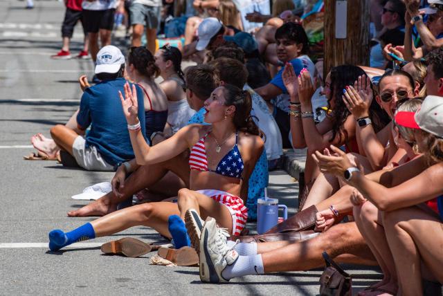 People cheer during the 4th of July parade in Bristol, Rhode Island, on July 4, 2026. Millions of Americans celebrated the country's 250th birthday on Saturday -- a landmark celebration that comes at a time of deep political division, with a president determined to put his stamp on the festivities. Washington's traditional fireworks display on the National Mall -- lined with monuments celebrating the nation's Founding Fathers -- has been super-sized, and is being touted as the biggest ever. (Photo by JOSEPH PREZIOSO / AFP)
