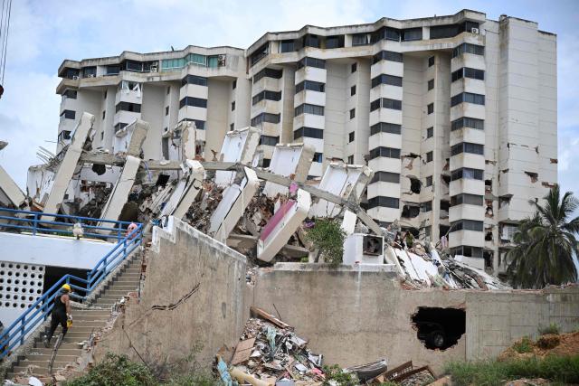 EDITORS NOTE: Graphic content / View of a destroyed building in La Guaira, Venezuela on July 4, 2026, following the June 24 twin earthquakes. With little hope of finding loved ones alive, frustrated families of those affected by Venezuela's double earthquakes clamor for help to recover their loved one's bodies as uncertainty grows over the death toll from the tragedy. (Photo by Raul ARBOLEDA / AFP)