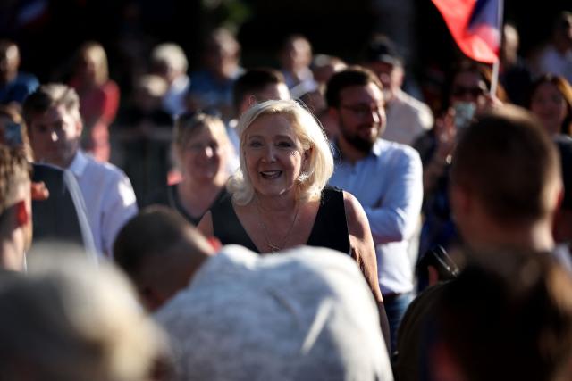 President of Rassemblement National parliamentary group Marine Le Pen (C) arrives to attend a RN party event "La fete champetre" in Lievin, northern France on July 4, 2026. (Photo by SIMON WOHLFAHRT / AFP)