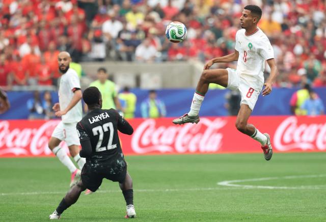Morocco's midfielder #08 Azzedine Ounahi jumps for the ball past Canada's defender #22 Richie Laryea during the 2026 World Cup round of 16 football match between Canada and Morocco at the Houston Stadium in Houston on July 4, 2026.  (Photo by Thomas COEX / AFP)