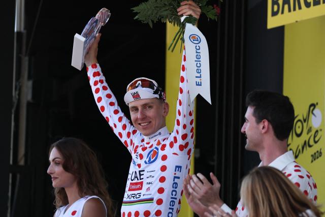 UAE Team Emirates - XRG's Slovenian rider Tadej Pogacar celebrates on the podium with the best climber's polka dot (dotted) jersey after the 1st stage of the 113th edition of the Tour de France cycling race, a 19,6 km team time trial stage in and around Barcelona in northeastern Spain, on July 4, 2026. (Photo by Anne-Christine POUJOULAT / AFP)