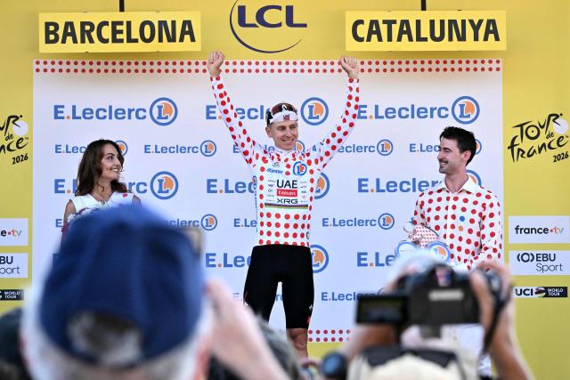 UAE Team Emirates - XRG's Slovenian rider Tadej Pogacar celebrates on the podium with the best climber's polka dot (dotted) jersey after the 1st stage of the 113th edition of the Tour de France cycling race, a 19,6 km team time trial stage in and around Barcelona in northeastern Spain, on July 4, 2026. (Photo by Jeff PACHOUD / AFP)