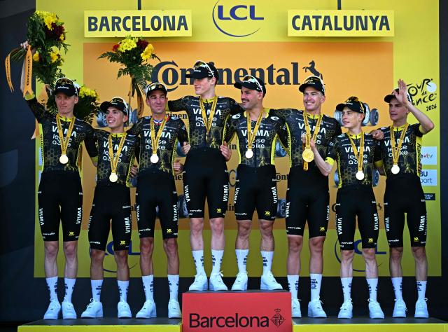 Team Visma | Lease a Bike's team celebrates on the podium after winning the 1st stage of the 113th edition of the Tour de France cycling race, a 19 km team time trial stage in and around Barcelona in northeastern Spain, on July 4, 2026. (Photo by Loic VENANCE / AFP)