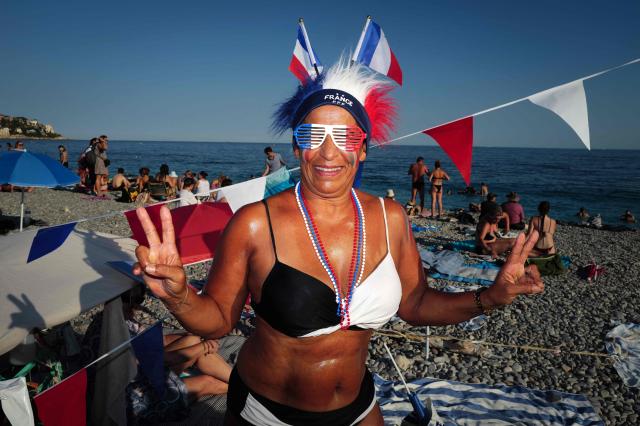 France fan Tina poses on the beach ahead of the 2026 World Cup round of 16 football match between Paraguay and France in the French riviera city of Nice, on July 4, 2026. (Photo by Valery HACHE / AFP)