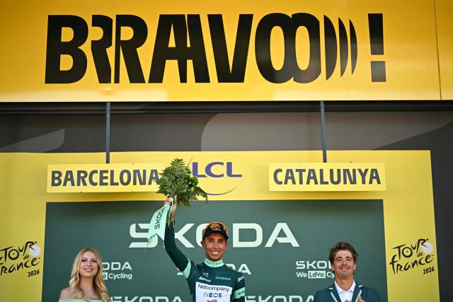 Netcompany INEOS team's Colombian rider Egan Bernal celebrates on the podium with the best sprinter's green jersey after the 1st stage of the 113th edition of the Tour de France cycling race, a 19 km team time trial stage in and around Barcelona in northeastern Spain, on July 4, 2026. (Photo by Loic VENANCE / AFP)