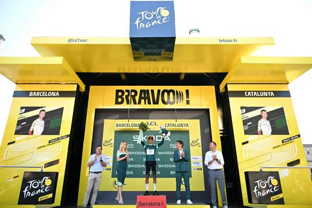 Netcompany INEOS team's Colombian rider Egan Bernal celebrates on the podium with the best sprinter's green jersey after the 1st stage of the 113th edition of the Tour de France cycling race, a 19 km team time trial stage in and around Barcelona in northeastern Spain, on July 4, 2026. (Photo by Loic VENANCE / AFP)