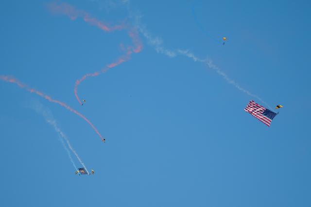 Members of the US Army parachute team "Golden Knights" and US Navy parachute team "Leap Frogs" perform with a US flag during the "Salute to America" Independence Day celebration on the National Mall in Washington, DC, on July 4, 2026. The nation is marking the 250th anniversary of the United States Declaration of Indpendence. (Photo by Ken Cedeno / AFP)