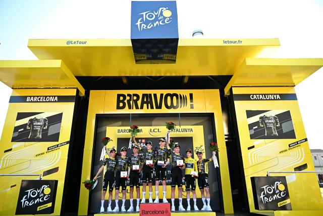 Team Visma - Lease a bike team riders celebrates on the podium after winning the 1st stage of the 113th edition of the Tour de France cycling race, a 19 km team time trial stage in and around Barcelona in northeastern Spain, on July 4, 2026. (Photo by Loic VENANCE / AFP)