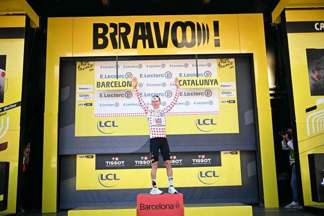 UAE Team Emirates - XRG's Slovenian rider Tadej Pogacar celebrates on the podium with the best climber's polka dot (dotted) jersey after the 1st stage of the 113th edition of the Tour de France cycling race, a 19,6 km team time trial stage in and around Barcelona in northeastern Spain, on July 4, 2026. (Photo by Loic VENANCE / AFP)