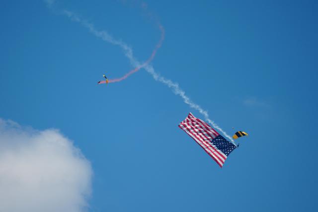 Members of the US Army parachute team "Golden Knights" and US Navy parachute team "Leap Frogs" perform with a US flag during the "Salute to America" Independence Day celebration on the National Mall in Washington, DC, on July 4, 2026. The nation is marking the 250th anniversary of the United States Declaration of Indpendence. (Photo by Ken Cedeno / AFP)