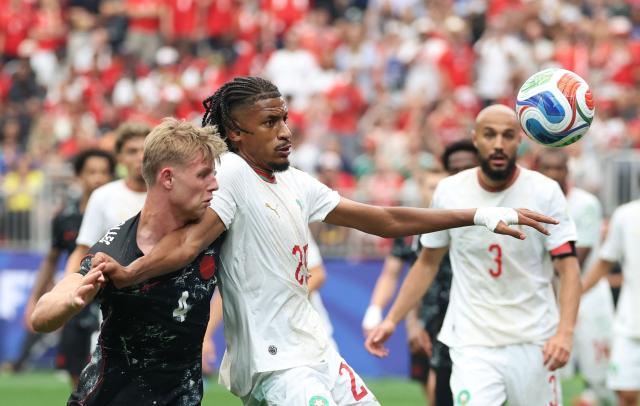 Canada's defender #04 Luc de Fougerolles and Morocco's defender #25 Redouane Halhal fight for the ball during the 2026 World Cup round of 16 football match between Canada and Morocco at the Houston Stadium in Houston on July 4, 2026.  (Photo by Thomas COEX / AFP)