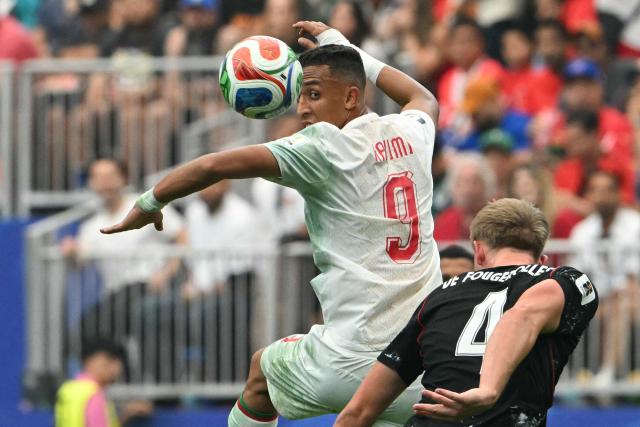 Morocco's forward #09 Soufiane Rahimi heads the ball past Canada's defender #04 Luc de Fougerolles during the 2026 World Cup round of 16 football match between Canada and Morocco at the Houston Stadium in Houston on July 4, 2026.  (Photo by RONALDO SCHEMIDT / AFP)