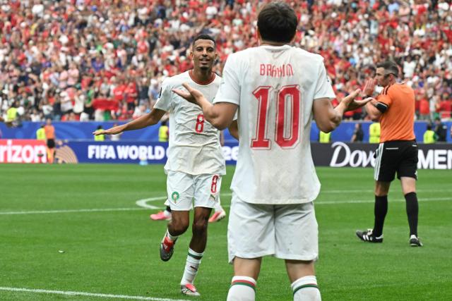 Morocco's midfielder #08 Azzedine Ounahi celebrates scoring his team's second goal with teammate forward #10 Brahim Diaz during the 2026 World Cup round of 16 football match between Canada and Morocco at the Houston Stadium in Houston on July 4, 2026.  (Photo by RONALDO SCHEMIDT / AFP)