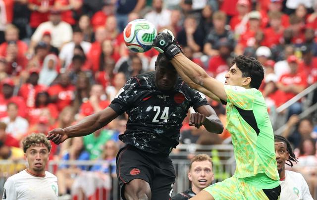 Morocco's goalkeeper #01 Yassine Bounou clears the ball past Canada's forward #24 Promise David during the 2026 World Cup round of 16 football match between Canada and Morocco at the Houston Stadium in Houston on July 4, 2026.  (Photo by Thomas COEX / AFP)