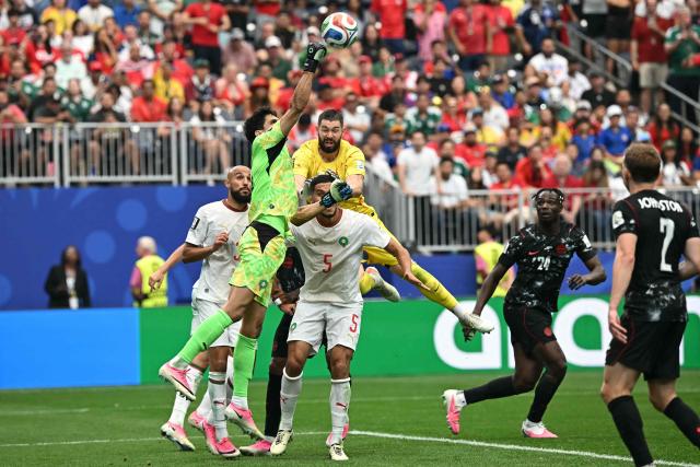Morocco's goalkeeper #01 Yassine Bounou clears the ball past Canada's goalkeeper #16 Maxime Crepeau during the 2026 World Cup round of 16 football match between Canada and Morocco at the Houston Stadium in Houston on July 4, 2026.  (Photo by Paul ELLIS / AFP)