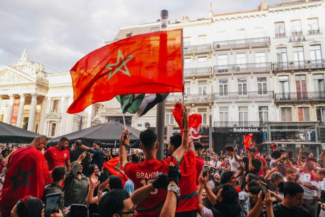 Supporters of Morocco wave Morocco national falgs as they watch the 2026 World Cup round of 16 football match between Canada and Morocco, in Brussels on July 4, 2026. (Photo by Marius BURGELMANS / Belga / AFP) / Belgium OUT