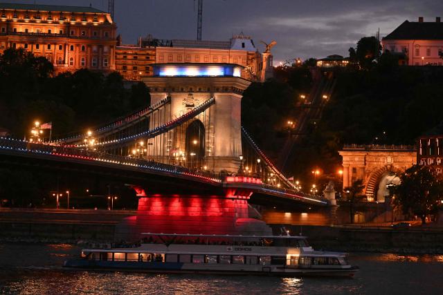 Hungary’s oldest bridge, the Chain Bridge is illuminated in the colors of the United States flag in downtown Budapest on July 4, 2026. The iconic landmark is illuminated in red, white and blue to mark the 250th anniversary of American independence. The special lighting transforms one of Budapest’s most recognizable symbols into a striking tribute spanning the Danube. (Photo by Attila KISBENEDEK / AFP)