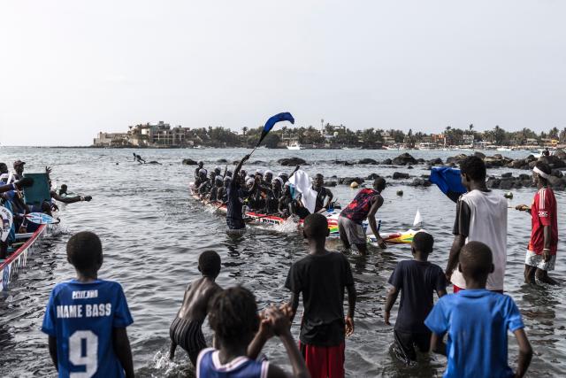 Paddlers from the Xataxely community in Ngor village celebrate after winning one of the races during the annual Ngor Regatta, off the coast of Ngor island, in Dakar, on July 4, 2026. Sailors and fishermen from different communities gathered for the annual Ngor Regatta, a sporting event celebrating the culture and traditions of the Lebou people, a traditional fishing community in Senegal. (Photo by PATRICK MEINHARDT / AFP)