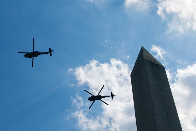 US military helicopters fly by the Washington Monument during the "Salute to America" Independence Day celebration on the National Mall in Washington, DC, on July 4, 2026. The nation is marking the 250th anniversary of the United States Declaration of Indpendence. (Photo by Amid FARAHI / AFP)