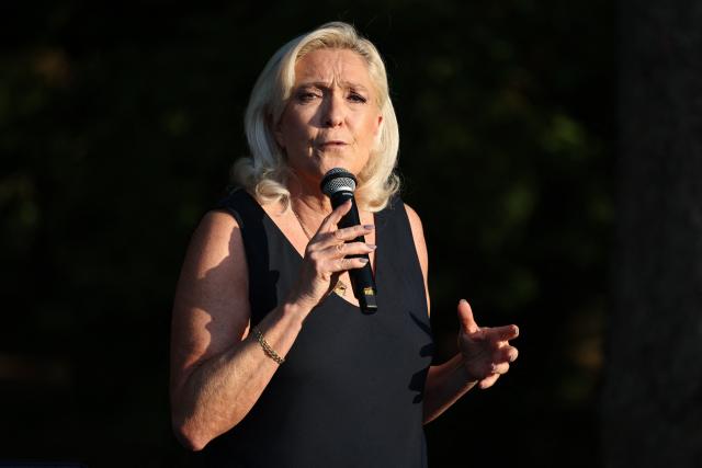President of Rassemblement National parliamentary group Marine Le Pen addresses the audience during a RN party event "La fete champetre" in Lievin, northern France on July 4, 2026. (Photo by SIMON WOHLFAHRT / AFP)