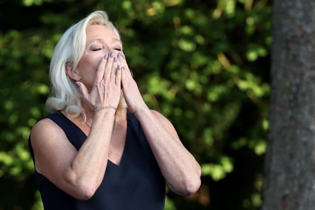 President of Rassemblement National parliamentary group Marine Le Pen addresses the audience during a RN party event "La fete champetre" in Lievin, northern France on July 4, 2026. (Photo by SIMON WOHLFAHRT / AFP)