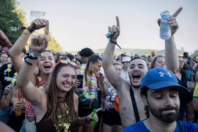 Festivalgoers cheer as US folk band ‘The Lumineers’ perform on stage during the 36th edition of the Les Eurockeennes de Belfort music festival, in Sermamagny, eastern France, on July 4, 2026. (Photo by ROMEO BOETZLE / AFP)