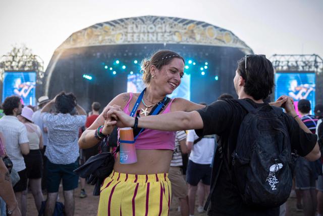 Festivalgoers dance as US folk band ‘The Lumineers’ perform on stage during the 36th edition of the Les Eurockeennes de Belfort music festival, in Sermamagny, eastern France, on July 4, 2026. (Photo by ROMEO BOETZLE / AFP)