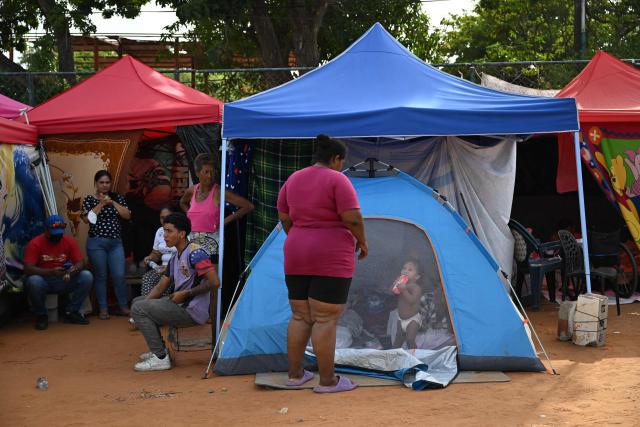 Survivors remain at a makeshift camp in La Guaira, Venezuela on July 4, 2026, following the June 24 twin earthquakes. With little hope of finding loved ones alive, frustrated families of those affected by Venezuela's double earthquakes clamor for help to recover their loved one's bodies as uncertainty grows over the death toll from the tragedy. (Photo by Raul ARBOLEDA / AFP)