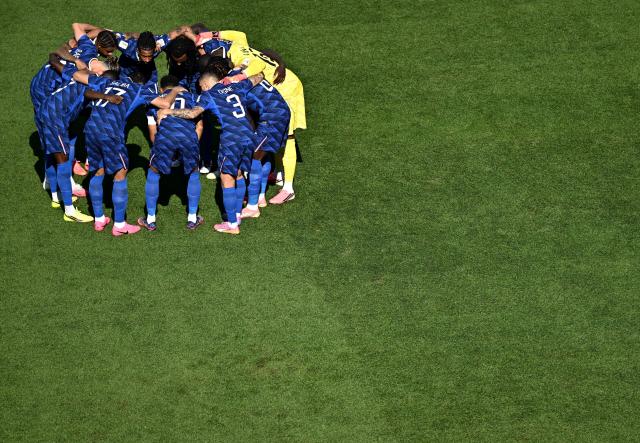 France's players gather in a circle ahead of the 2026 World Cup round of 16 football match between Paraguay and France at the Philadelphia Stadium in Philadelphia on July 4, 2026.  (Photo by Jewel SAMAD / AFP)